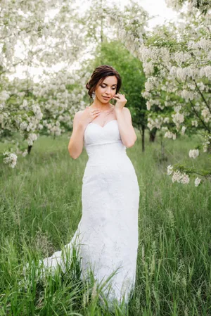 Attractive bride smiling in the park on her wedding day