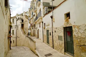 Medieval village street with ancient stone buildings.