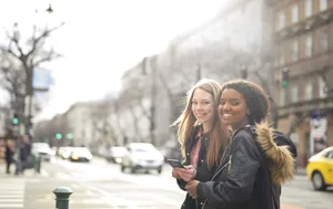 Smiling Businesswoman Outdoors with Phone