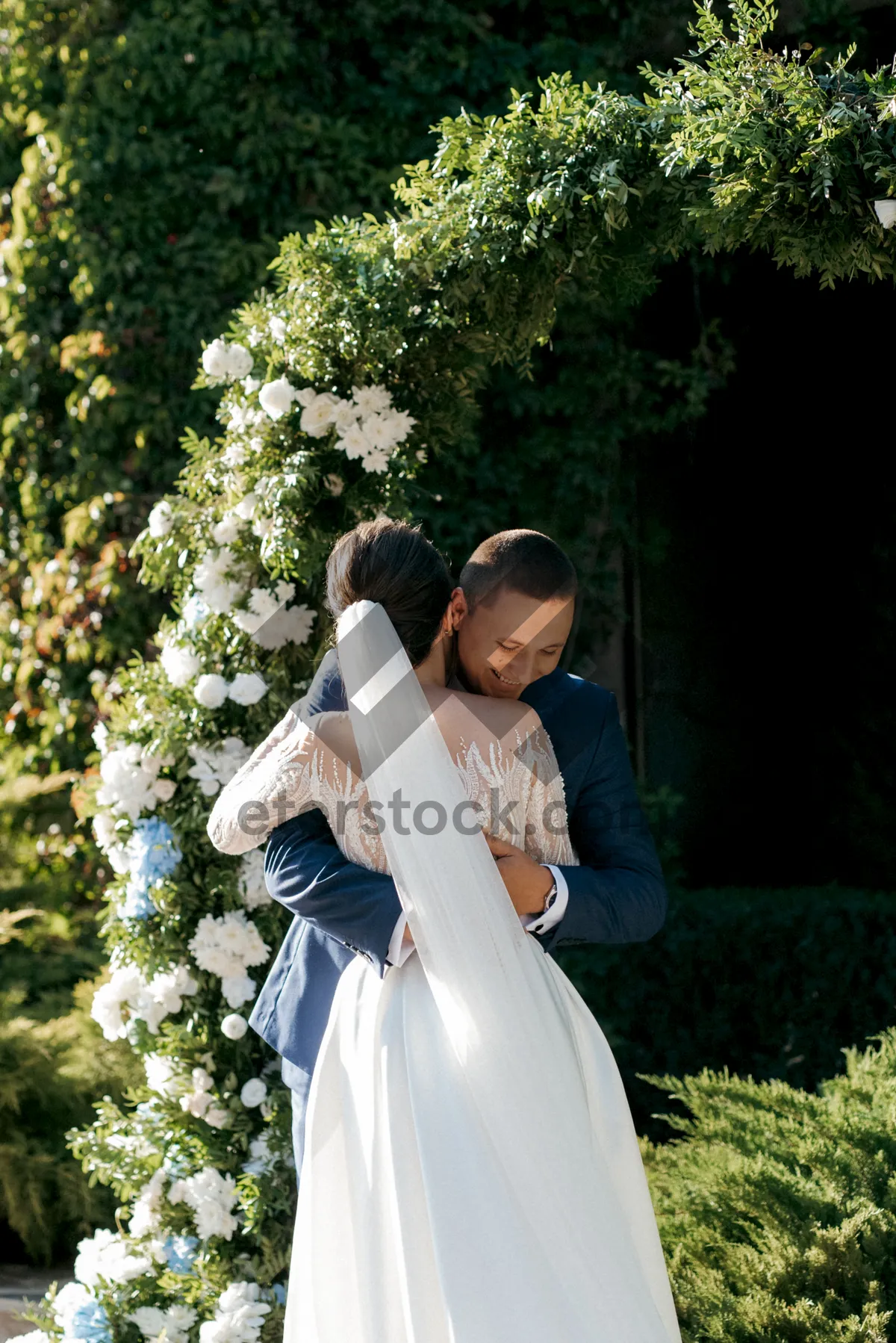 Picture of Happy bride and groom celebrating their wedding day outdoors.