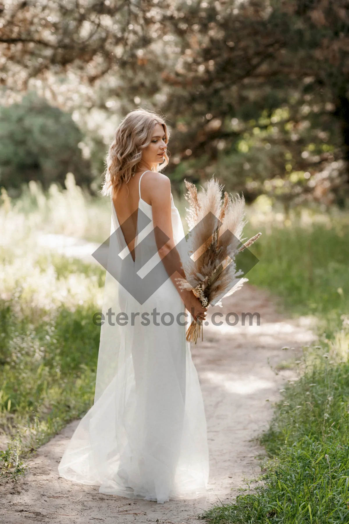 Picture of Blond bride in elegant wedding gown smiling happily