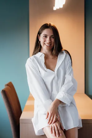 Smiling Businesswoman in Professional Attire at Office