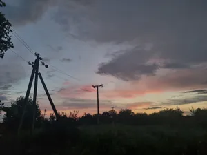 Silhouette energy tower against sunset landscape.