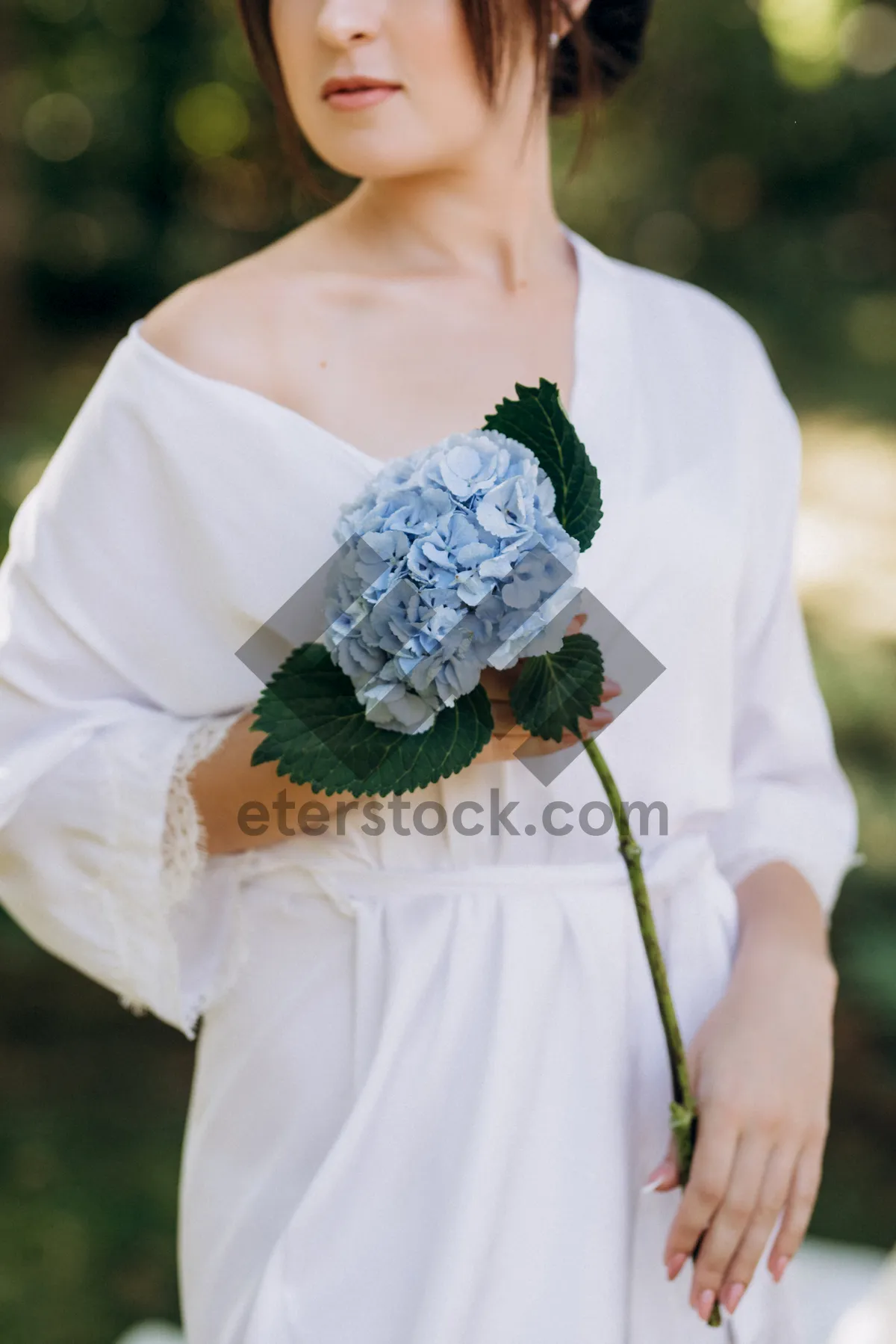 Picture of Happy bride and groom celebrate marriage outdoors with flowers