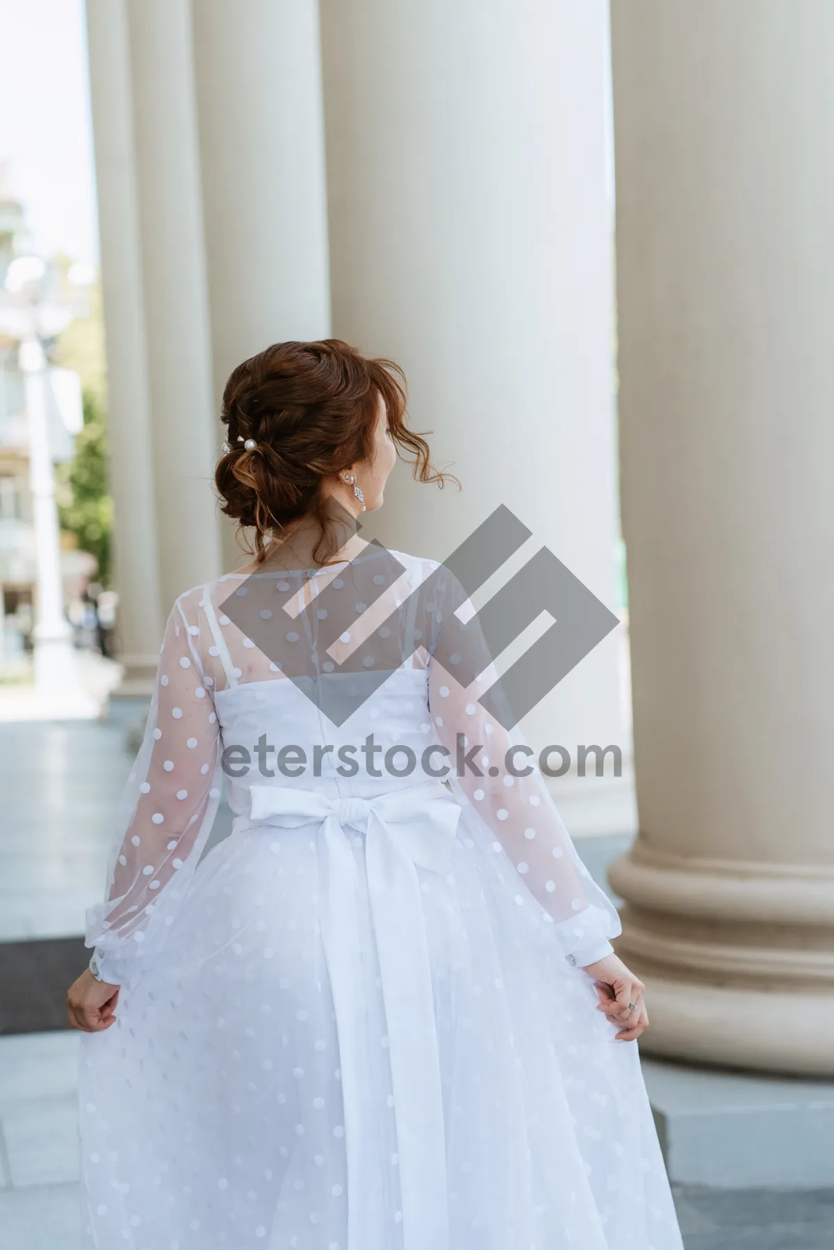 Picture of Attractive bride posing in elegant wedding gown