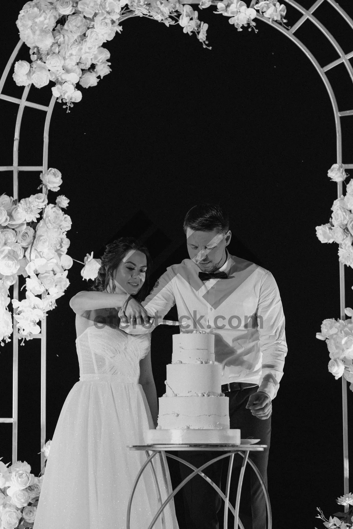 Picture of Happy couple celebrating wedding ceremony with flower bouquet.