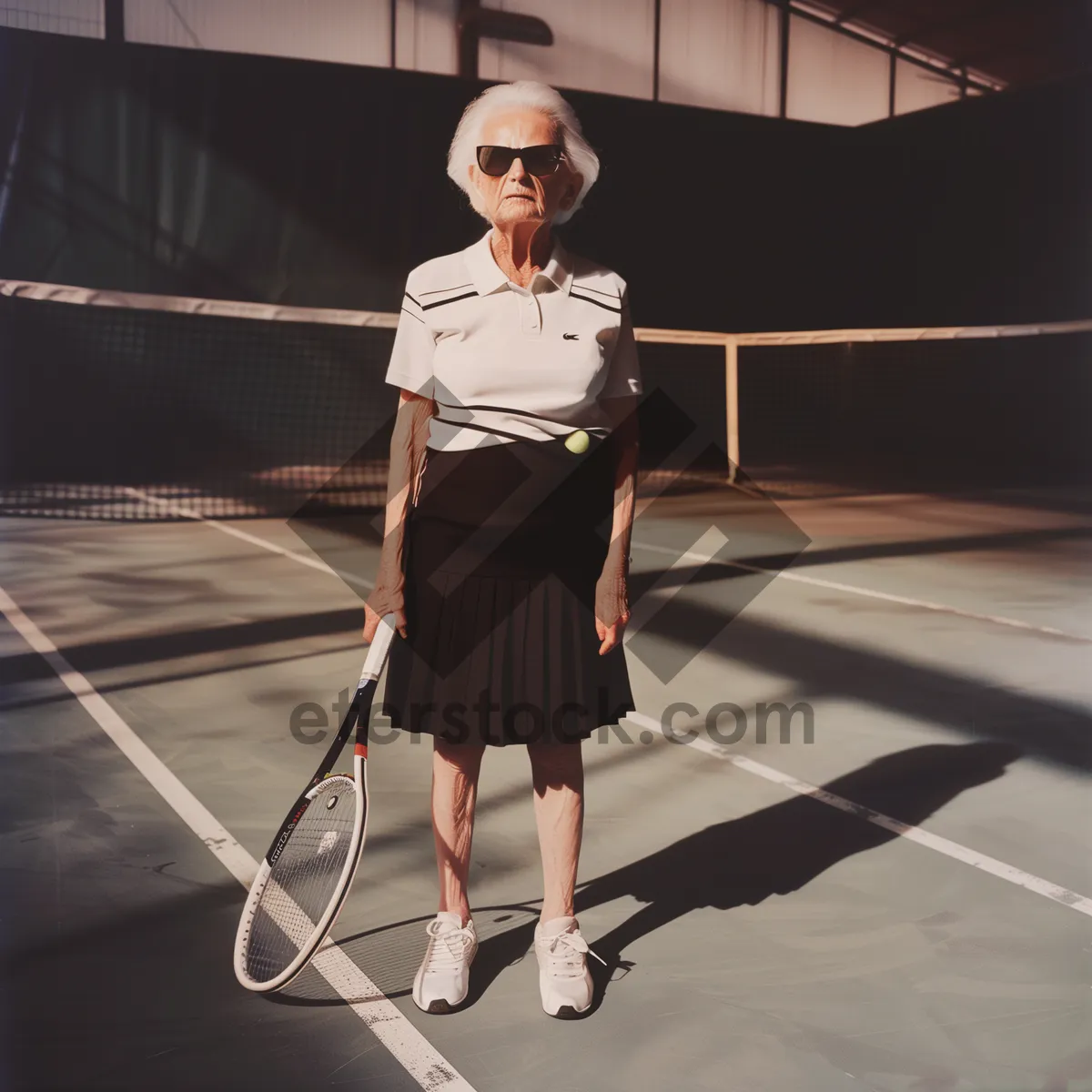 Picture of Active male tennis player on court with racket