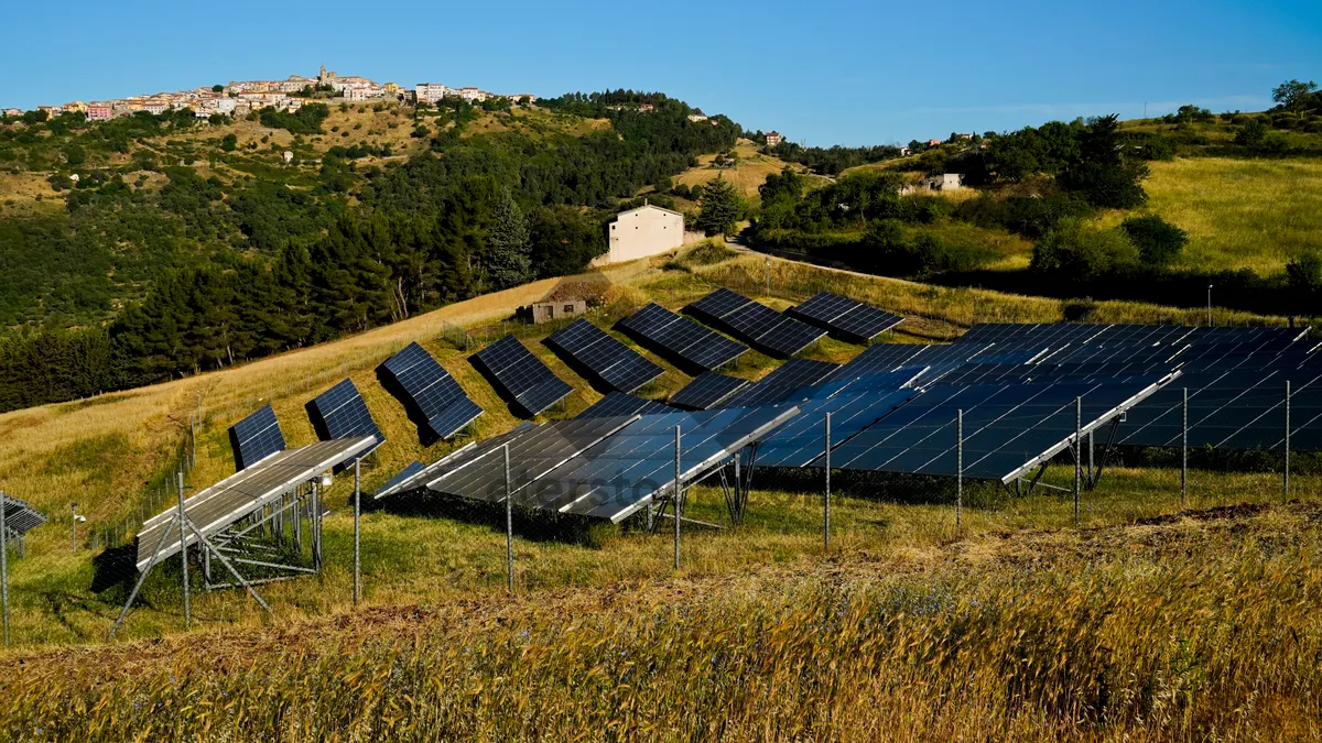 Picture of Rural solar panel array under clear blue sky