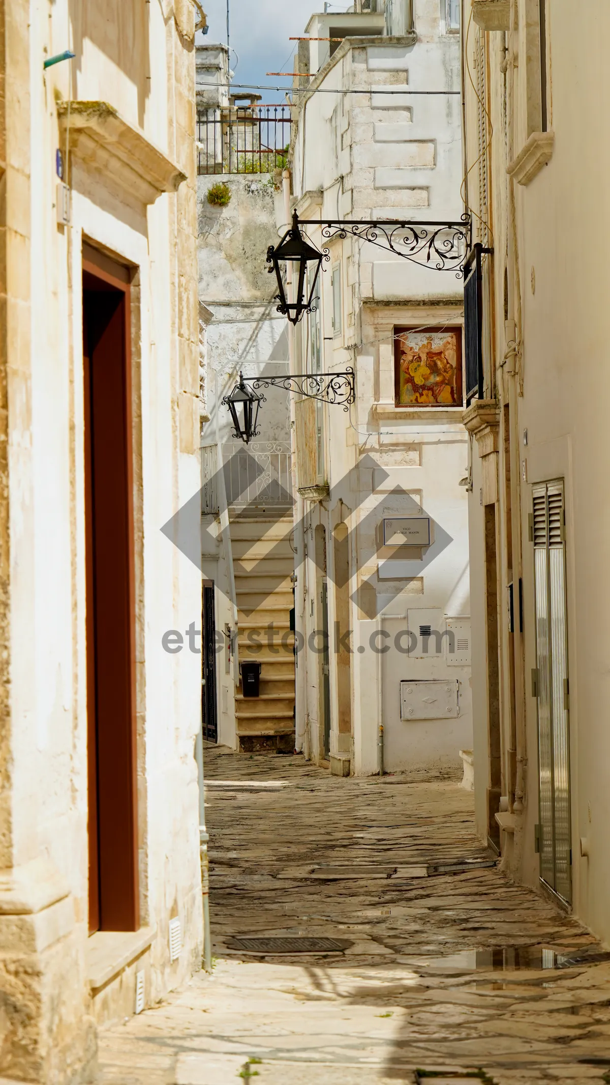 Picture of Old architecture with windows and doors on street.