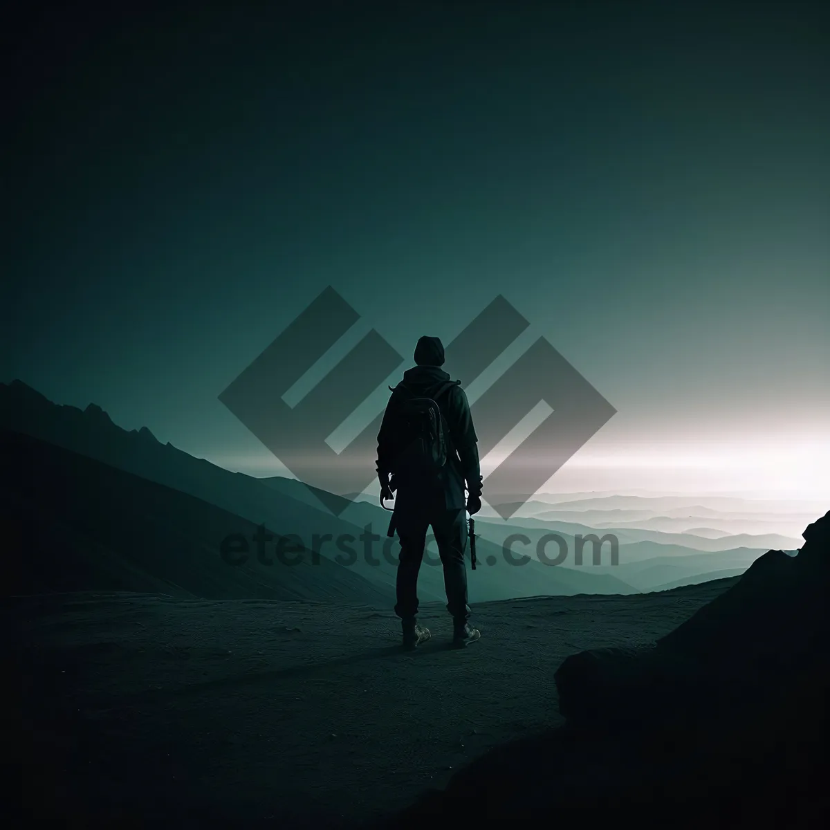 Picture of Man Hiking a Mountain at Sunset with Silhouette