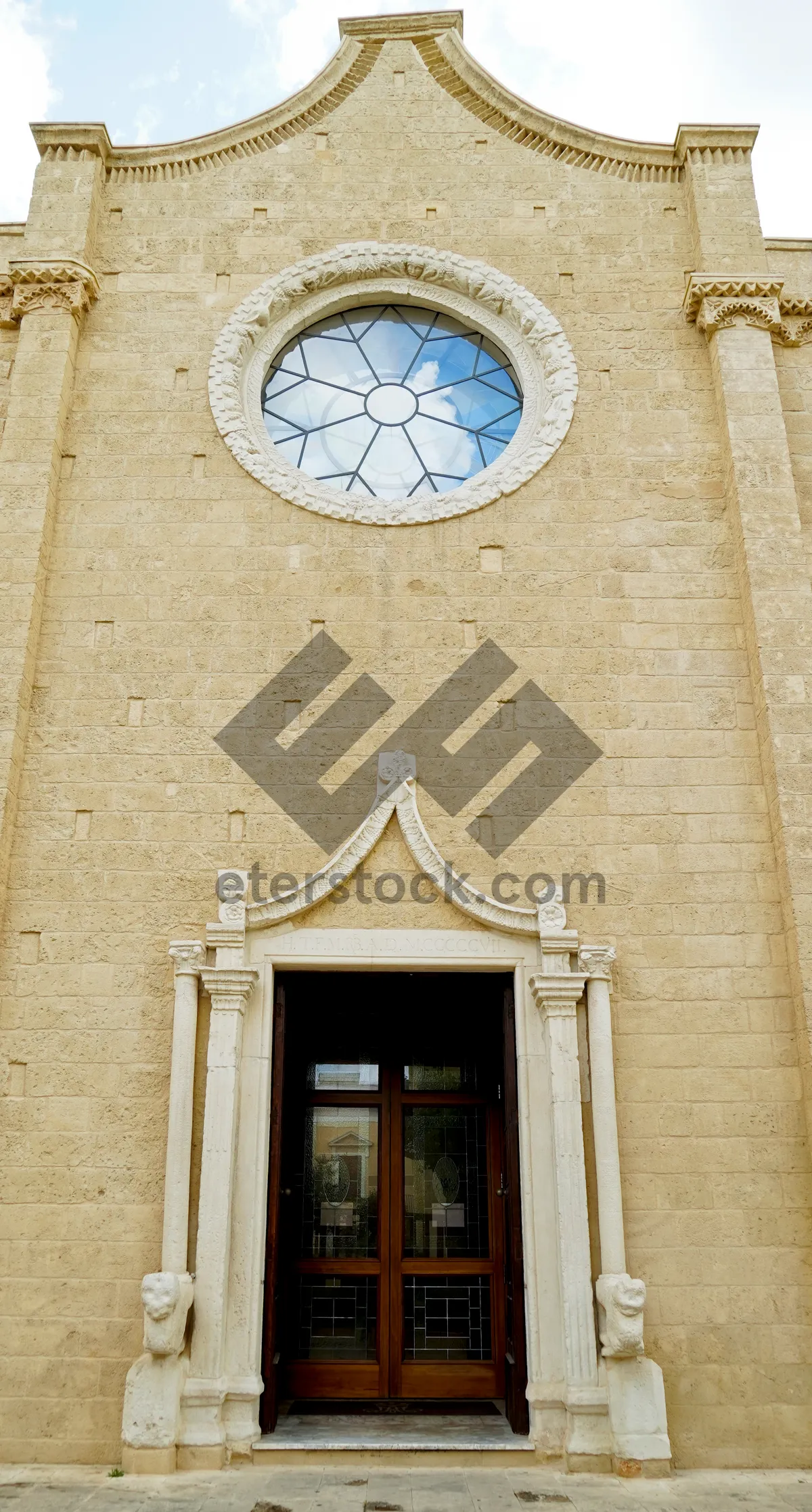 Picture of Ancient cathedral facade with arched windows and doors.