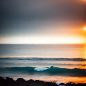 Golden Horizon: Serene Beach Sunset with Reflecting Waves