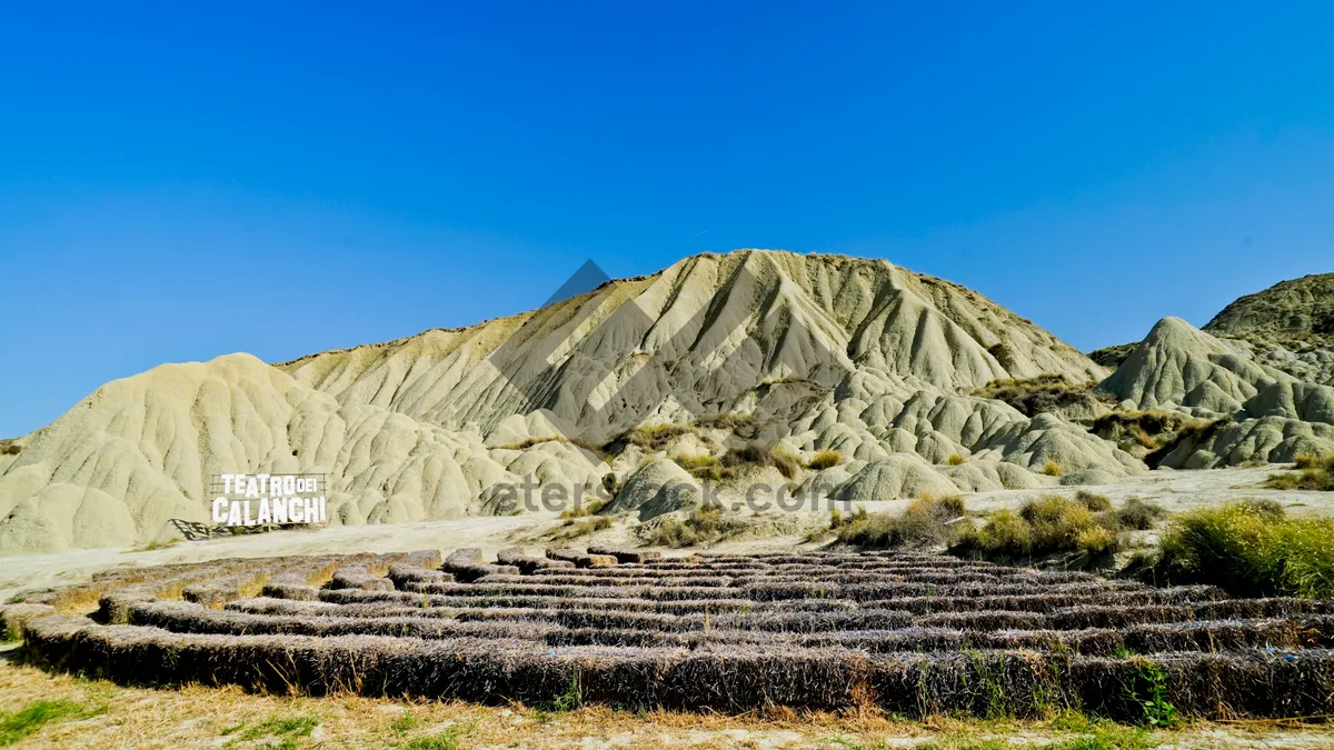 Picture of Ancient Mountain Stone Structure Amidst Desert Highland Landscape