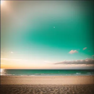 Sunlit Coastal Oasis: Turquoise Waves on Sandy Beach