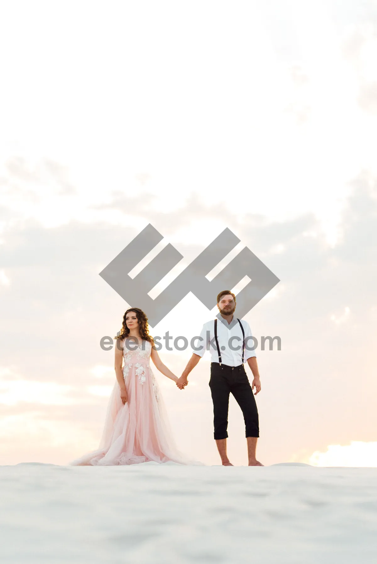 Picture of Happy newlywed couple on beach, smiling and in love.