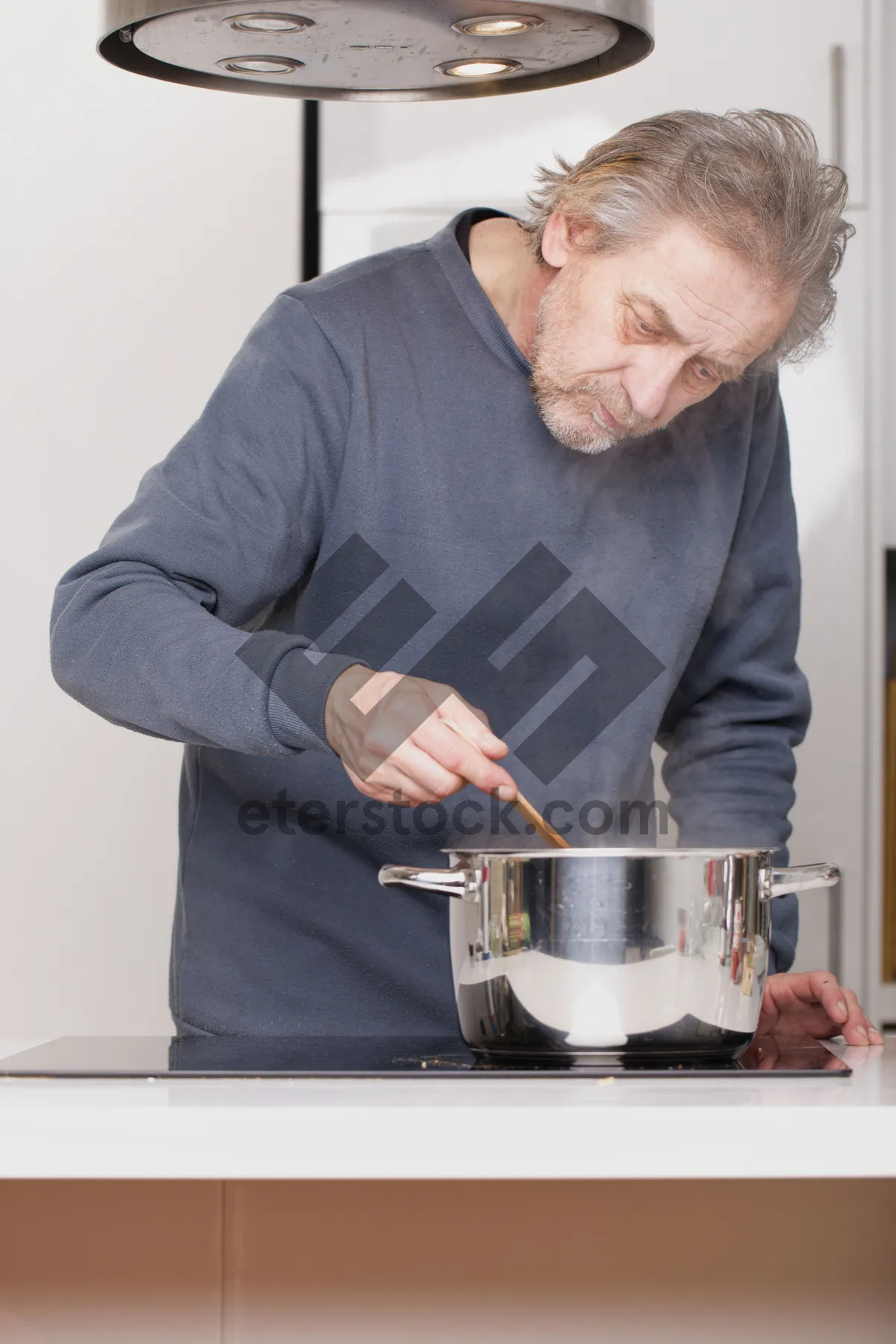 Picture of Happy male chef cooking in kitchen with crock pot