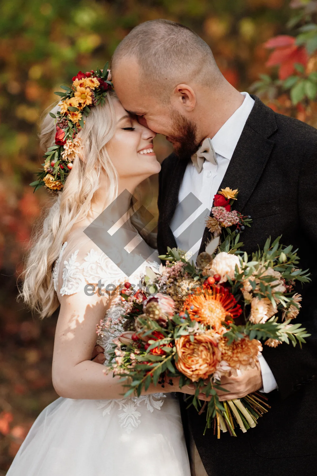 Picture of Happy couple celebrating wedding outdoors with flower bouquet