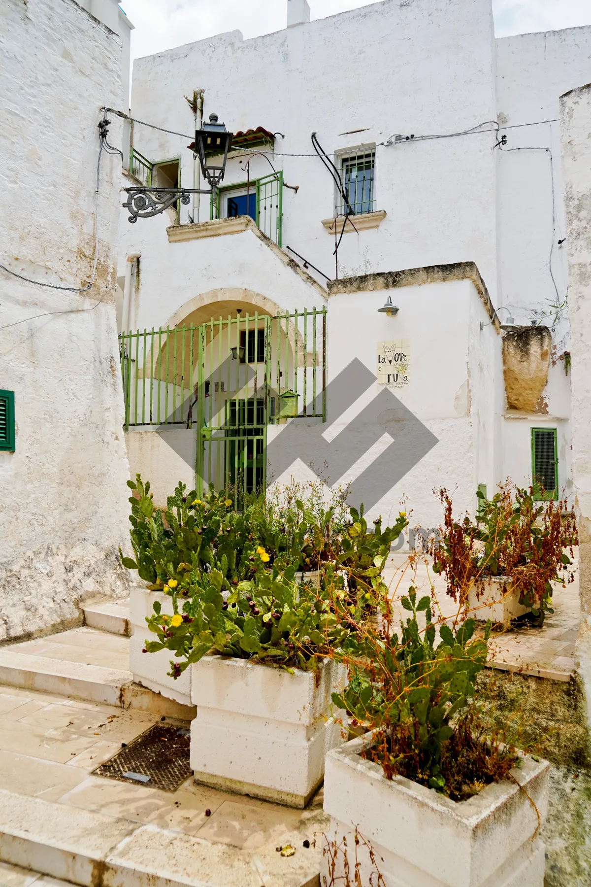 Picture of Historic stucco home with balcony and flowers.