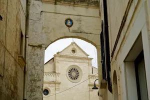 Historic Cathedral Tower with Cross and Arched Windows