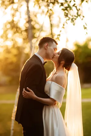 Happy newlywed couple at outdoor park wedding portrait.