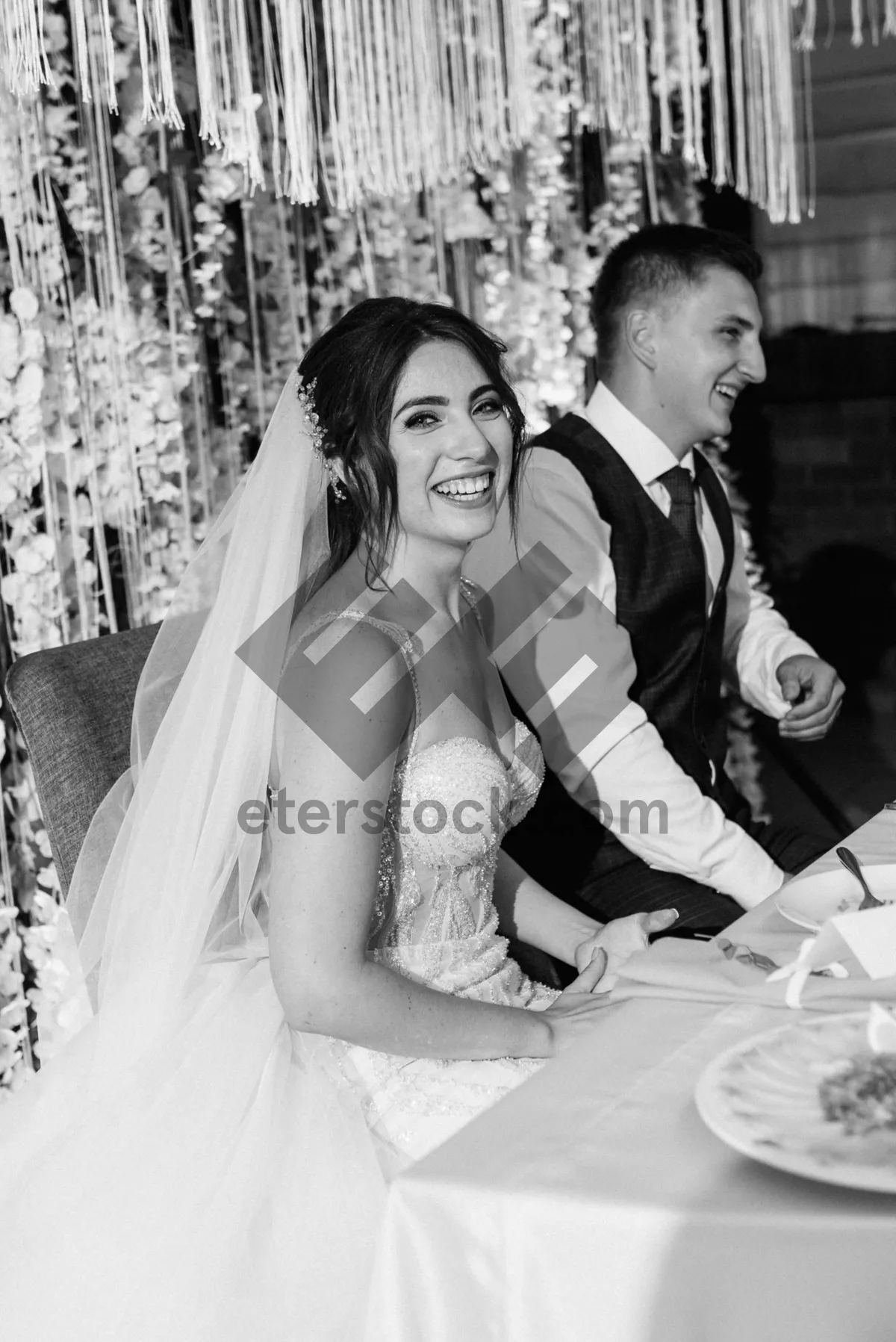 Picture of Happy Couple at Wedding with Bouquet of Flowers