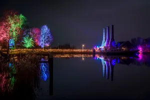 City skyline with vibrant night lights reflecting on river