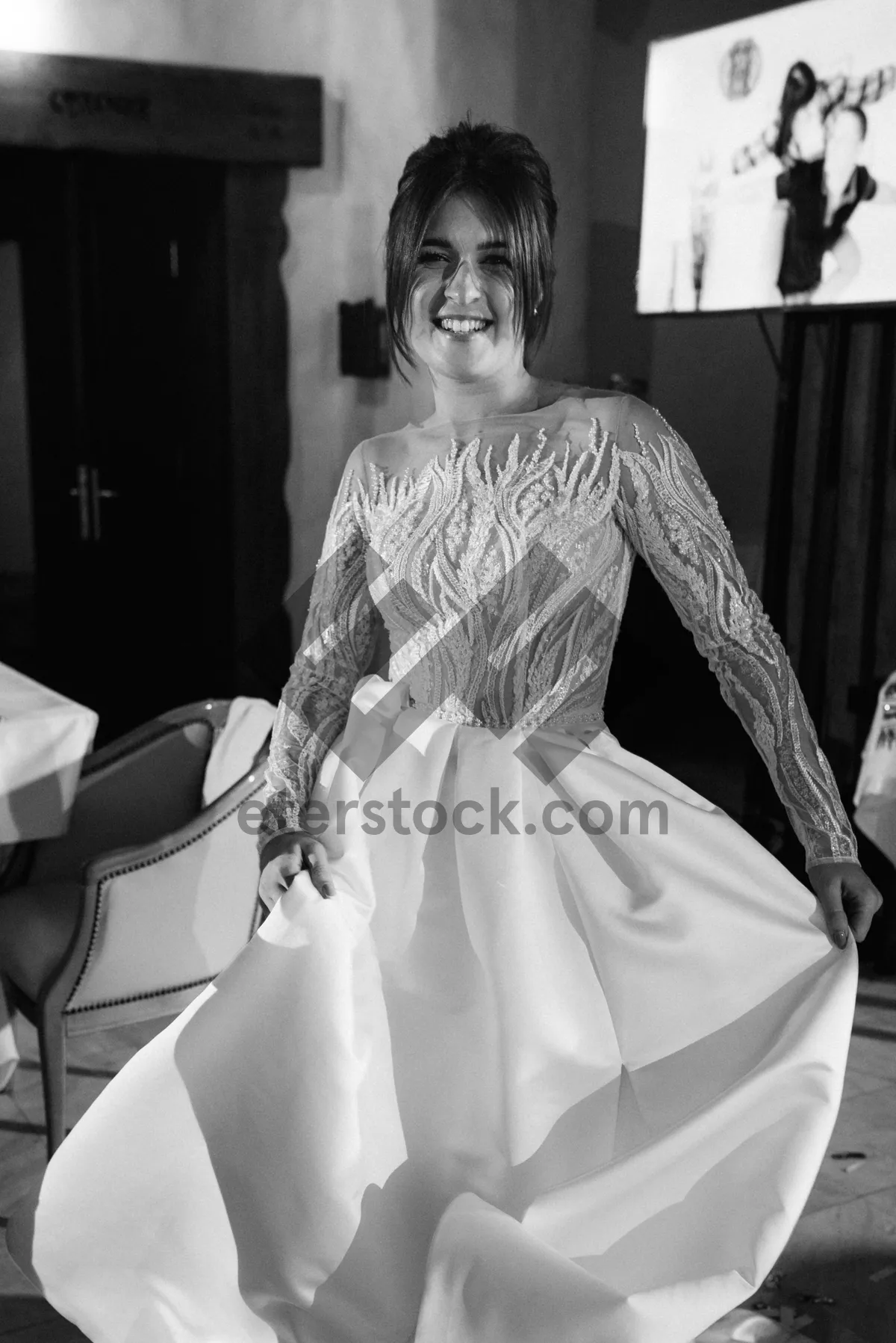 Picture of Happy bride in elegant wedding dress with bouquet