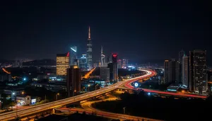 Modern business district skyline at night with river reflection.