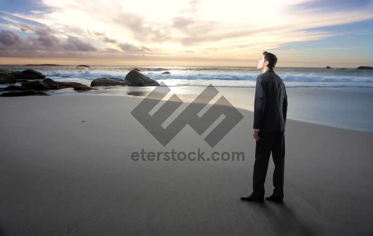 Picture of Silhouette of Man on Beach at Sunset.