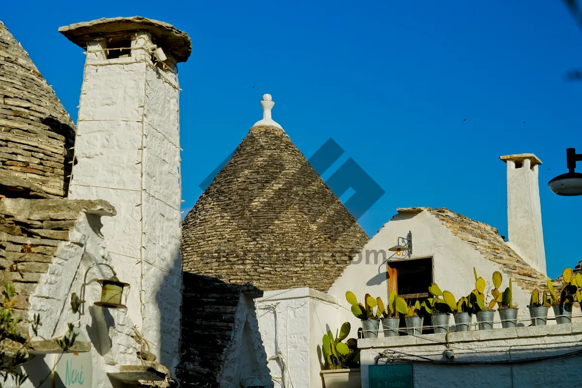 Picture of Historic brick bell tower church with tiled roof.