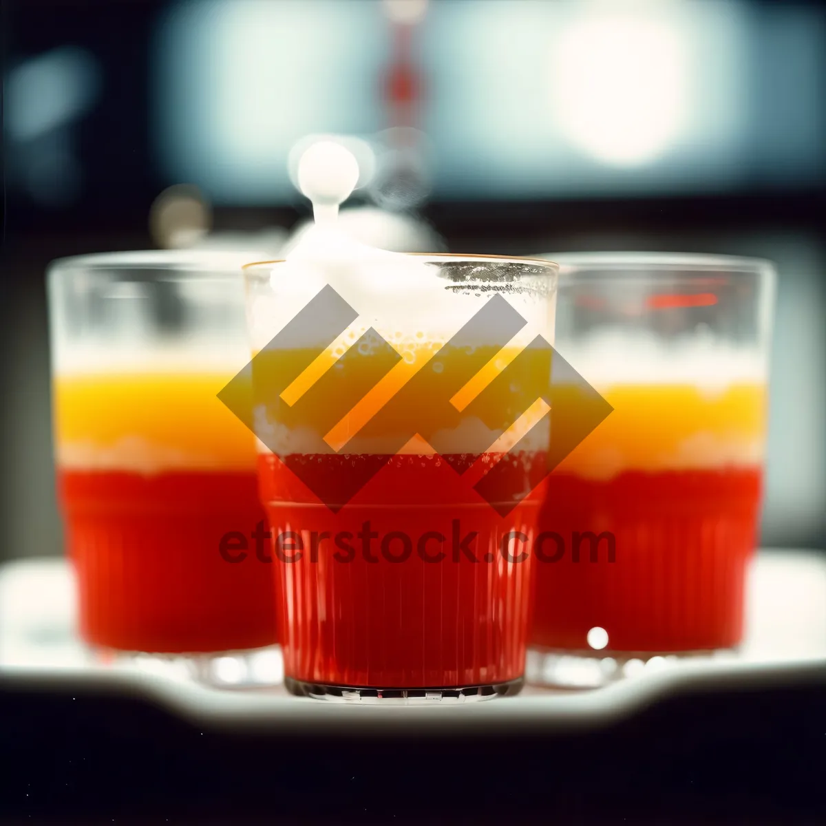 Picture of Fresh orange juice in a glass placed on a plate.