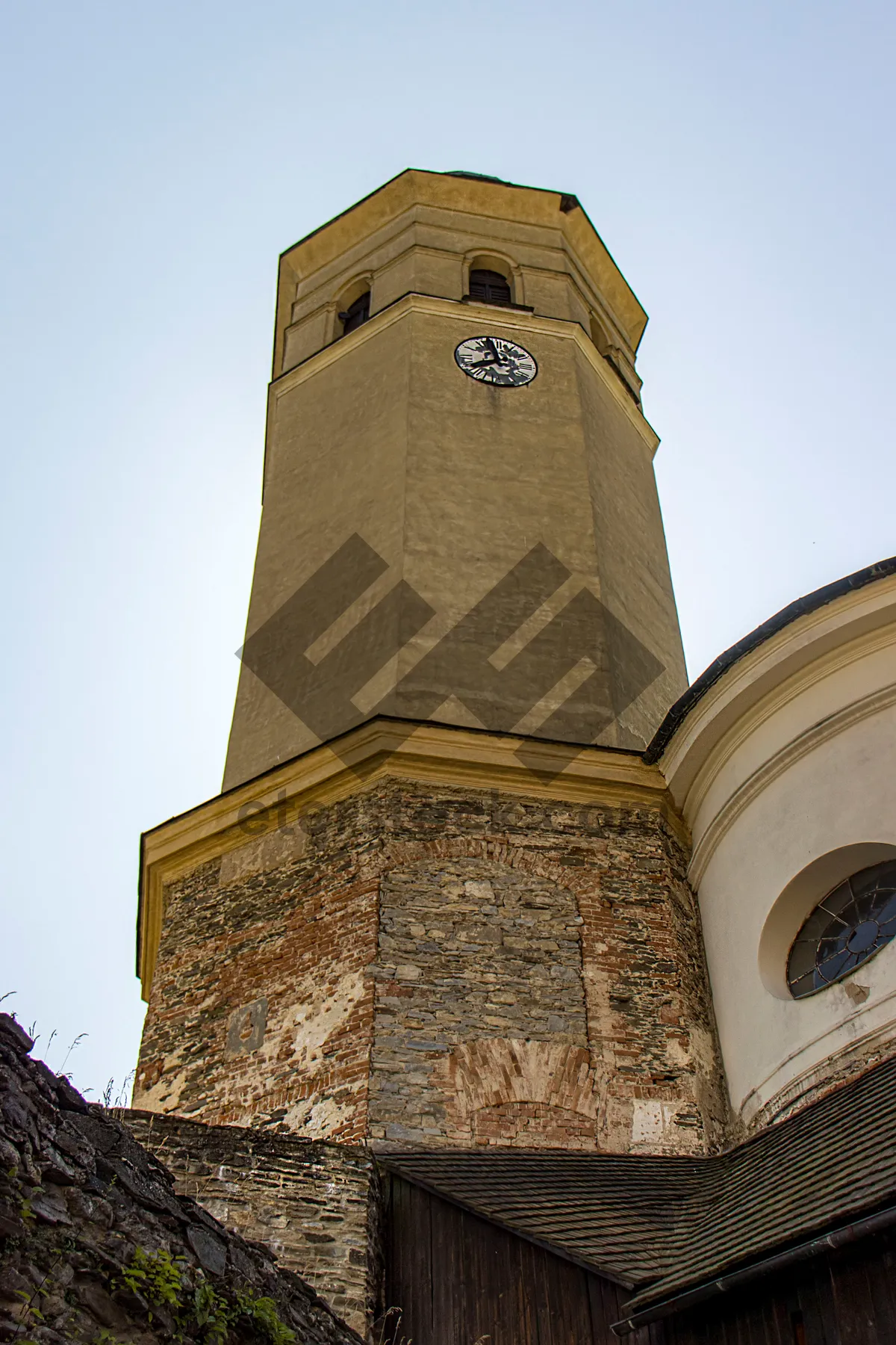 Picture of Old cathedral bell tower in city skyline.