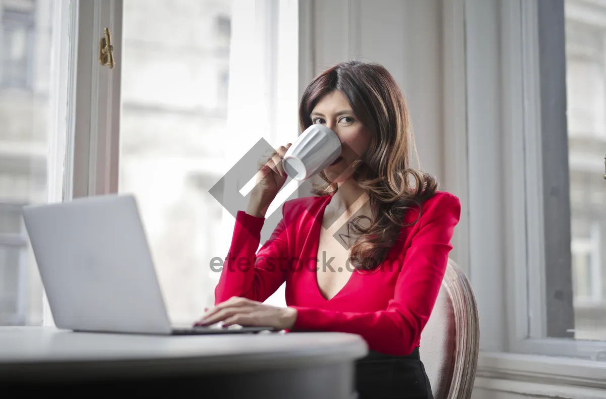 Picture of Confident businesswoman smiling at laptop in office