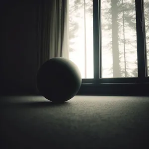Black Pool Table Ball on Windowsill